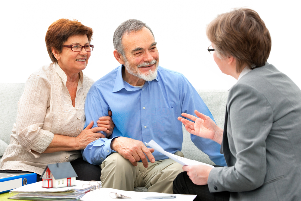 retired couple meeting with female financial advisor
